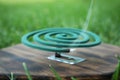 Smouldering insect repellent coil on board outdoors