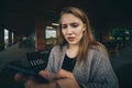 Closeup portrait funny shocked anxious scared young girl looking at phone seeing bad news photos message with disgusting Royalty Free Stock Photo