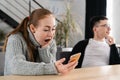 SMS. Closeup portrait funny shocked anxious scared young girl looking at phone seeing bad news photos message with Royalty Free Stock Photo