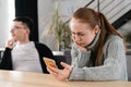 SMS. Closeup portrait funny shocked anxious scared young girl looking at phone seeing bad news photos message with Royalty Free Stock Photo