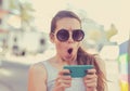 SMS. Closeup portrait funny shocked anxious scared young girl looking at phone Royalty Free Stock Photo