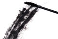 Black wand and smudged mascara on white background Royalty Free Stock Photo