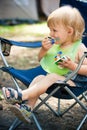 Smudgy baby boy eat in camp Royalty Free Stock Photo