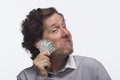 Smug man holding dollar bill, horizontal Royalty Free Stock Photo