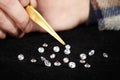 Smuggler of diamonds evaluating gems for dealing on velvet pad Royalty Free Stock Photo