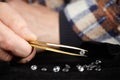 Smuggler of diamonds evaluating gems for dealing on velvet pad Royalty Free Stock Photo