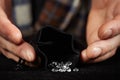 Smuggler of diamonds packing gems to velvet bag for dealing