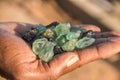 Smuggler showing smuggled precious and semi precious stones excavated in illegal mine