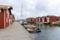 Walking wooden bridge along the chanel with fishing cottages and boats