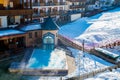 Aerial shot of wooden houses in the middle of the mountains in the Austrian Alps during winter Royalty Free Stock Photo