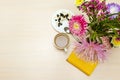 Snack with cottage cheese and coffee at the table with asters in a vase and a yellow notepad. Royalty Free Stock Photo