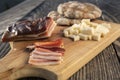 Snack with delicious South Tyrolean smoked bacon and cheese with flat bread lying on a rustic table Royalty Free Stock Photo