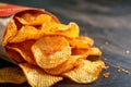 Snack indulgence Spicy BBQ potato chips, thin slices in open bag