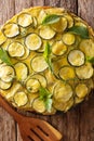 Snack Italian summer zucchini tart with flowers close-up. Vertic