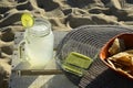 Snack of lemonade with lime slice, green salsa and tortilla chips at the beach Royalty Free Stock Photo