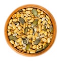 Snack mix. Soybeans, pumpkin and sunflower seeds in wooden bowl Royalty Free Stock Photo