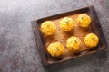 Snack muffins cooked with mashed potatoes, bacon and cheddar cheese close-up on a wooden board. horizontal top view Royalty Free Stock Photo