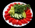 A snack for a picnic - fresh cucumbers, peppers and tomatoes isolated