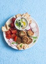 Snack plate. Cauliflower meatballs, tomatoes, radish, gluten-free, cracker and sauce. Healthy vegetarian snack.