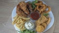 Snack platter - cheese sticks, chicken nugget, onion rings, french fries mix of snacks and sauces . Beer board. Royalty Free Stock Photo