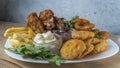 Snack platter - cheese sticks, chicken nugget, onion rings, french fries mix of snacks and sauces . Beer board Royalty Free Stock Photo