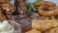 Snack platter - cheese sticks, chicken nugget, onion rings, french fries mix of snacks and sauces . Beer board Royalty Free Stock Photo