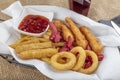 Snack platter - French fries,  spring rolls, fried sausage, chicken nugget, Turkish pastry, onion rings, potato croquette on plate Royalty Free Stock Photo