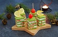 Snack, savoury spinach biscuit sandwices or canapes layered with cream cheese and salted salmon in Christmas and New Year style on Royalty Free Stock Photo