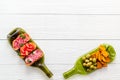 Snack set on wine bottles on white wooden desk from above copy space Royalty Free Stock Photo