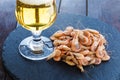 Snack from shrimps with a glass of beer on black stone plate and wooden table Royalty Free Stock Photo