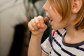 Snack time joy: A young boy, 10, munches on a sausage, embracing the delicious pause