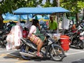 A snack vendor on a motorbike selling food near Patong beach