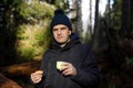 Snack on a walk in the woods. man with thermos in nature