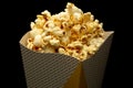 Snack of watching movie concept, Sweet popcorn in paper cup on black background Royalty Free Stock Photo