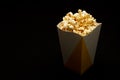 Snack of watching movie concept, Sweet popcorn in paper cup on black background Royalty Free Stock Photo