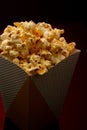 Snack of watching movie concept, Sweet popcorn in paper cup on red and black background Royalty Free Stock Photo