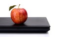 Snack whole red apple with juice on laptop Royalty Free Stock Photo