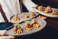 Snacks and appetizers. Meat cuts on a wooden plate with horseradish and croutons on a black table. Fresh lettuce Royalty Free Stock Photo