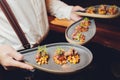 Snacks and appetizers. Meat cuts on a wooden plate with horseradish and croutons on a black table. Fresh lettuce Royalty Free Stock Photo