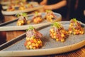 Snacks and appetizers. Meat cuts on a wooden plate with horseradish and croutons on a black table. Fresh lettuce Royalty Free Stock Photo