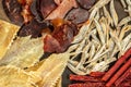 snacks for beer, Dried fish mix on wood plate. dried fish chorizo sausage meat carpaccio on a dark background. place for text, top