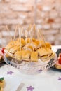Snacks canapes on a round glass dish on a festive Banquet table