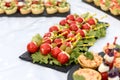 Snacks and canapes and tartlets stuffed in the assortment on the buffet table.