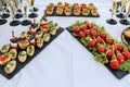 Snacks and canapes and tartlets stuffed in the assortment on the buffet table.