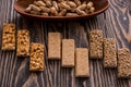 Snacks - mix of energy bars with peanut, sesame and sunflower seeds on a wooden background. Nuts in caramel, honey Snack food. Unh Royalty Free Stock Photo