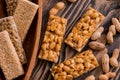 Snacks - mix of energy bars with peanut, sesame and sunflower seeds on a wooden background. Nuts in caramel, honey Snack food. Unh Royalty Free Stock Photo