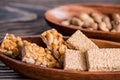 Snacks - mix of energy bars with peanut, sesame and sunflower seeds on a wooden background. Nuts in caramel, honey Snack food. Unh Royalty Free Stock Photo