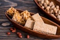 Snacks - mix of energy bars with peanut, sesame and sunflower seeds on a wooden background. Nuts in caramel, honey Snack food. Unh Royalty Free Stock Photo