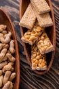 Snacks - mix of energy bars with peanut, sesame and sunflower seeds on a wooden background. Nuts in caramel, honey Snack food. Unh Royalty Free Stock Photo