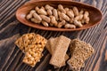 Snacks - mix of energy bars with peanut, sesame and sunflower seeds on a wooden background. Nuts in caramel, honey Snack food. Unh Royalty Free Stock Photo